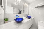 Custom LED backlit mirrors, marble flooring & walls with bathtub
